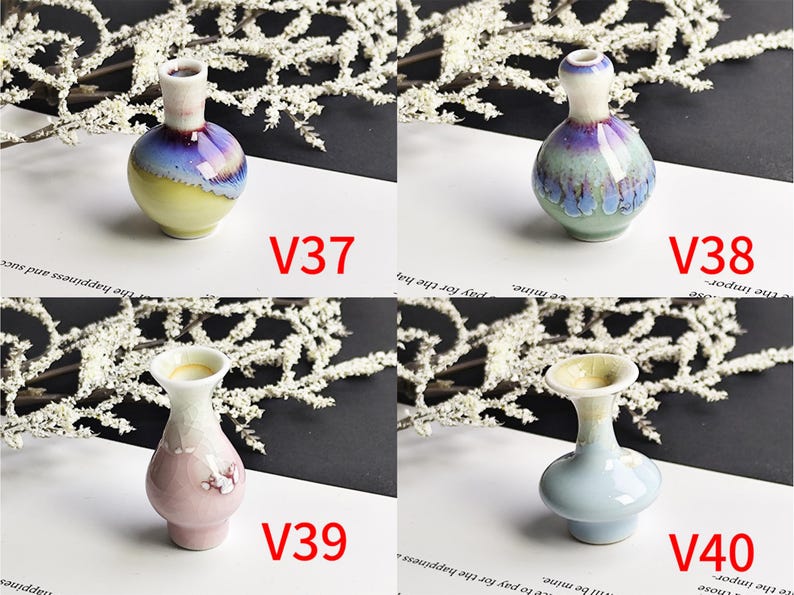 May include: Four small ceramic vases labeled V37, V38, V39, and V40. V37 has a yellow base and purple neck. V38 is round with a blue and purple glaze. V39 is pink with a flared rim. V40 is light blue with a wide, flared opening and smooth finish.