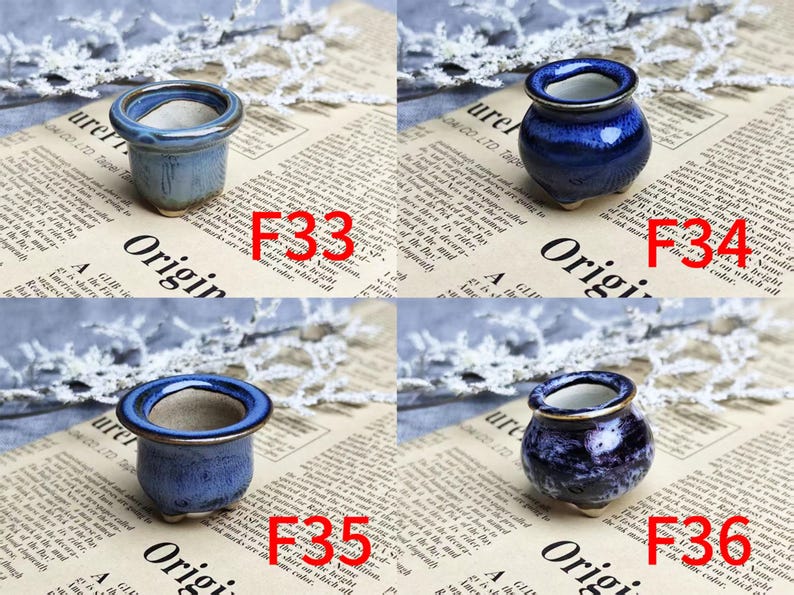 May include: Four small ceramic pots in shades of blue, each with a contrasting rim. The pots are displayed on a newspaper background with the word "Origin" visible. Each pot is labeled with a red number.