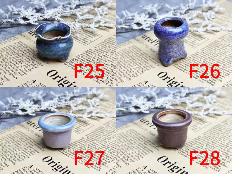 May include: Four small ceramic pots in shades of blue, purple, and brown are displayed. Each pot has a unique shape and design, with a textured or glazed finish. The pots are labeled with the letters "F" and numbers.
