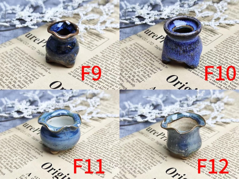 May include: Four small, handcrafted ceramic pots in shades of blue and brown. Each pot has a unique shape and glaze, with a wavy rim. The pots are displayed on a newspaper background.