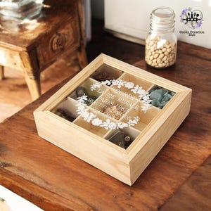 May include: A wooden box with a glass lid and six compartments. The box is decorated with a floral design and the text "Le Secret de la Vie Rurale Paris 1982 Beautiful Lavande Egalement".