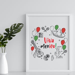 May include: A white framed print with a black and white illustration of a guitar, balloons, a sombrero, maracas, a cactus, and a calendar with the date 5 May. The text "Viva Mexico!" is written in black and white.