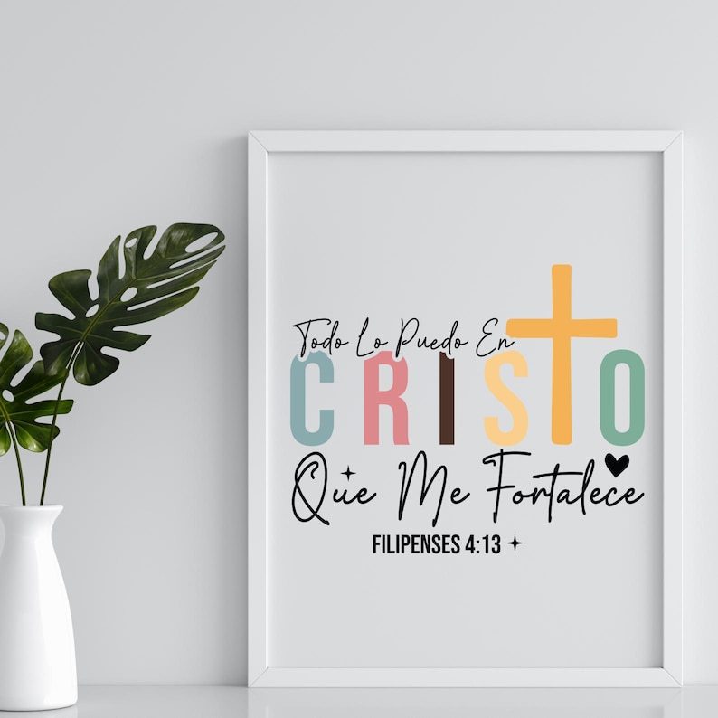 May include: A white framed print with a colorful design that says "Todo Lo Puedo En CRISTO Que Me Fortalece" with a cross and a heart. The text "Filipenses 4:13" is also included.