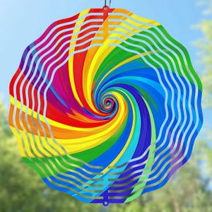 Może przedstawiać: Kolorowy wiatraczek w kształcie tęczy ze spiralnym wzorem. Wiatraczek jest wykonany z metalu i ma srebrne wykończenie.