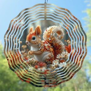 May include: A metal wind spinner with a swirling design features a colorful illustration of a squirrel adorned with flowers and leaves. The squirrel is surrounded by a floral pattern.