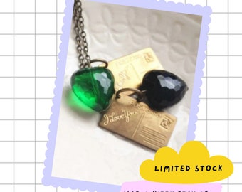 Green vintage-inspired lucite heart necklace with aged brass lpostcard charm