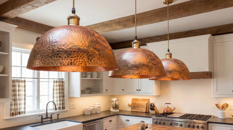 Hand-hammered copper pendant light with a large dome shape and warm reddish-orange metallic finish.