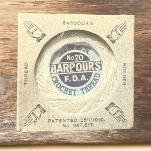 May include: Vintage Barbour's Crochet Thread in a cardboard holder. The label reads "No 70 Barbour's F.D.A. Crochet Thread." The holder has hand illustrations and text that reads "Thread" and "Holder." The patent date is 25/1/1910.