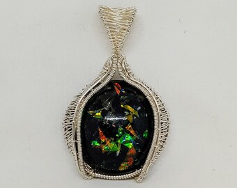 Woven Fine Silver captures a handcrafted resin cabachon pendant with a woven bail