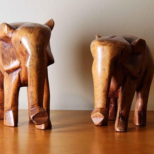 two adorable wooden elephant sculptures pair cute wooden carved hand made African woodwork art Africa animal