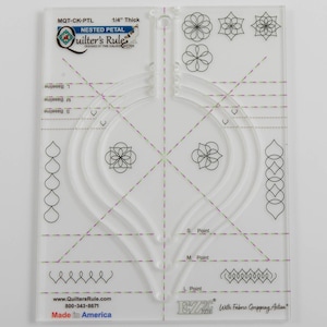 May include: Clear acrylic quilting template with nested petal design. Features curved edges, dashed lines, and floral patterns. Includes the text "Quilter's Rule" and "Made in America". The template is 1/4" thick.