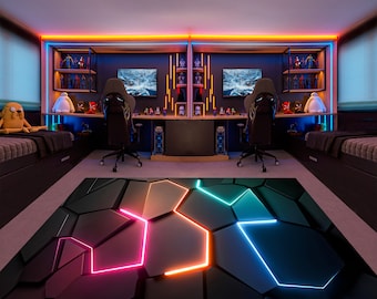 May include: A black gaming rug with a geometric pattern of black hexagons and neon pink, orange, and blue lines. The rug is in front of a gaming setup with two black gaming chairs, two computer monitors, and a desk with shelves.