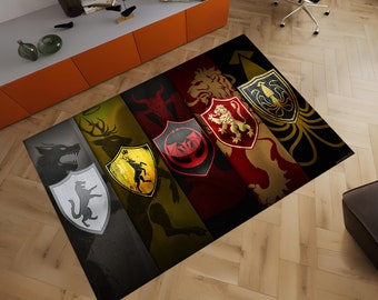 May include: A colorful rug with the sigils of the Great Houses of Westeros. The sigils are arranged in a horizontal row, with the Stark sigil (a direwolf) on the left, the Baratheon sigil (a crowned stag) in the center, and the Lannister sigil (a golden lion) on the right. The Targaryen sigil (a three-headed dragon) is in the upper left corner, and the Greyjoy sigil (a kraken) is in the upper right corner.