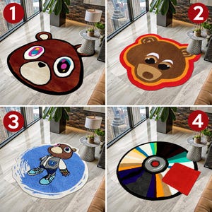 May include: Four different round rugs with various designs. The first rug features a brown bear with red and yellow accents. The second rug features a brown bear with red and yellow accents. The third rug features a blue and white rug with a cartoon bear wearing a blue shirt. The fourth rug features a colorful circular design with a red and white square in the center.