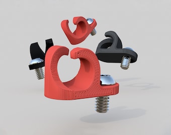 May include: Four cable clips, two red and two black, with screw-on attachments. The clips are designed to hold cables in place.