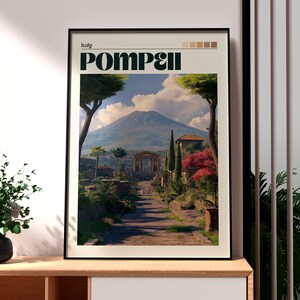 May include: Framed art print featuring a scenic view of Pompeii, Italy. The print displays a pathway leading towards a mountain, with lush greenery and architectural elements. The word "Pompeii" is prominently displayed.