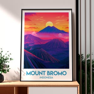 May include: A colorful poster with a graphic illustration of Mount Bromo in Indonesia. The poster features a vibrant sunset with a large sun in the sky and a mountain range in the foreground. The text "MOUNT BROMO INDONESIA" is printed at the bottom of the poster.