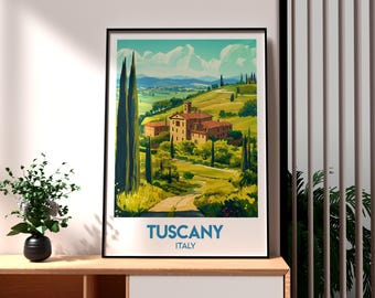 May include: Framed art print of a Tuscan landscape. The artwork depicts a sunny hillside with buildings, trees, and a winding road. The sky is blue with fluffy clouds. The text "TUSCANY ITALY" is at the bottom of the print.