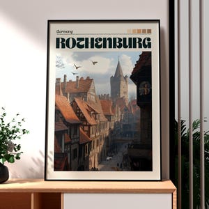 Könnte beinhalten: Gerahmter Kunstdruck mit einer detaillierten Illustration von Rothenburg, Deutschland. Das Kunstwerk zeigt eine historische europäische Stadt mit roten Ziegeldächern, einem hohen Kirchturm und dem Text "Rothenburg" in fetten Buchstaben. Der Druck ist in einem schwarzen Rahmen.