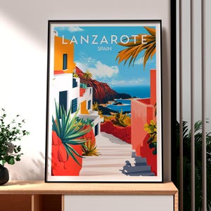 以下が含まれることがあります： 白い建物と赤い建物の景色が描かれたカラフルな旅行ポスター。階段が青い海へと続いています。ポスターの上部には「Lanzarote SPAIN」の文字があります。