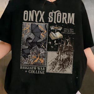 May include: Black t-shirt with a graphic print of a dragon, a castle, and a book. The text "ONYX STORM", "I WILL NOT DIE TO DAY I WILL SAVE HIM", and "BASGIATH WAR + COLLEGE" is printed on the shirt.