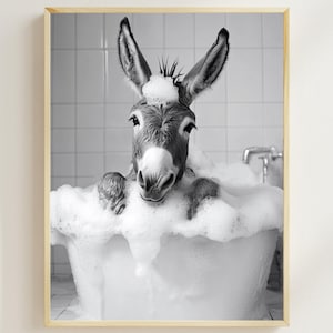 May include: A black and white photo of a donkey taking a bath in a white bathtub. The donkey is covered in bubbles and has a surprised expression on its face.