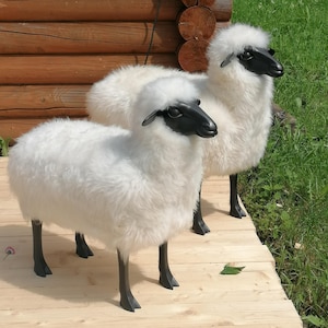 A pair of Lalanne-style sheep, large and small, made of light merino