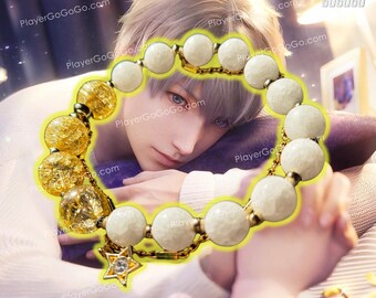 May include: A white and gold beaded bracelet with a star charm. The bracelet is made of small, round beads with a textured surface. The star charm is made of gold metal and has a clear crystal in the center.