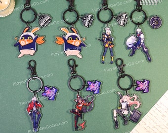 May include: A set of ten keychains featuring various anime characters. The keychains are made of clear acrylic and feature colourful designs. The keychains are attached to black metal rings.
