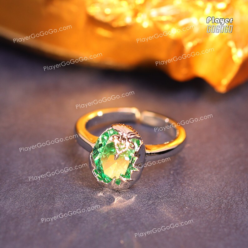 May include: A silver ring with a large green gemstone set in a decorative silver setting.