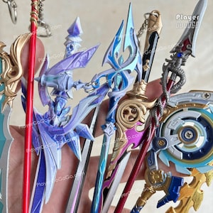 May include: A white ceramic mug with a black handle and the text "But First, Coffee" in a bold, black font. The mug is set against a blurred background, suggesting a cozy setting.