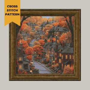 May include: A cross stitch pattern of a quaint town with houses and trees in autumn colors. The houses have lit windows and the trees have orange, yellow, and red leaves. The street is paved and there are streetlights.