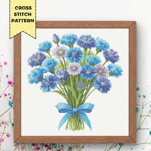May include: Cross stitch pattern of a bouquet of blue and purple flowers tied with a blue ribbon.