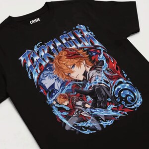 May include: A black t-shirt featuring a graphic print of an anime character with orange hair, wearing a red scarf and dark clothing. The text TARTAGLIA is printed in a metallic blue font above the character, surrounded by blue water splashes.