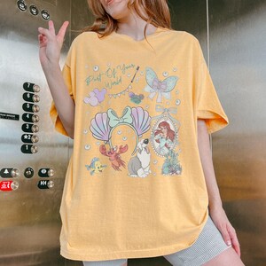 Coquette Bows Disney Ariel Princess Comfort Colors Shirt, The Little Mermaid Movie Tee, Mickey Balloon, Gift For Her, WDW Girl Trip Outfits Mustard (Comfort)