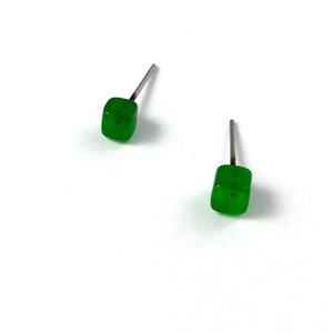 May include: A pair of small, square-shaped earrings with a green jade stone and silver posts.