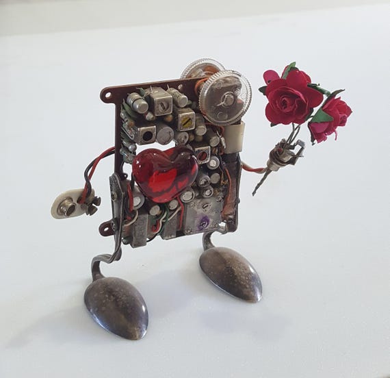 A one-of-a-kind steampunk robot built entirely from salvaged vintage electronics — no two are alike, and it radiates the 'a real human made this weird wonderful thing' energy.