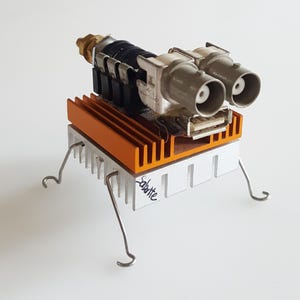 The Heat-Sink Bug-Robot is a rare, collectible, unique assemblage sculpture character made of electronics parts and wire.