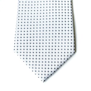 May include: A white tie with a small black and white checkered pattern.