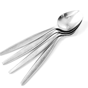 May include: Four silver spoons stacked on top of each other.