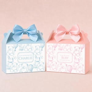 May include: Two pastel-coloured gift boxes, one blue and one pink, each with a satin bow. The boxes feature teddy bear designs and the text "To My New Big Brother Charlie" and "To My Big Sister Ruby".