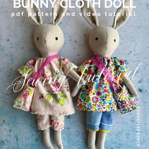 May include: Two handmade bunny cloth dolls with long ears, wearing floral print dresses and shorts. One doll has a pink floral dress and shorts, the other has a colorful floral top and denim shorts. The text "BUNNY CLOTH DOLL" is at the top.