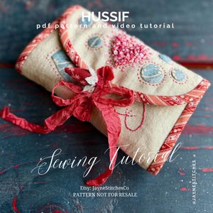 May include: A beige fabric sewing kit with red trim and a red ribbon bow. The kit is decorated with blue and pink embellishments and the word "HUSSIF" is at the top. The text "Sewing Tutorial" is also visible.