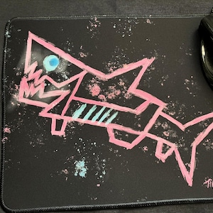 May include: A set of three ceramic mugs with a speckled, matte finish. The mugs are in shades of cream, light gray, and dark gray. Each mug has a simple, minimalist design, perfect for coffee or tea.