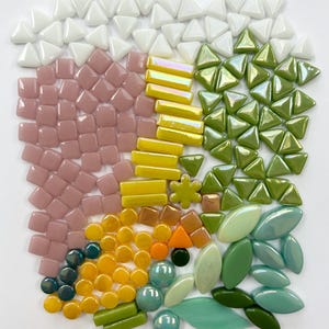 May include: Assortment of colorful glass mosaic tiles in various shapes and sizes, including squares, triangles, circles, and ovals. The tiles are in shades of white, pink, yellow, green, and blue.