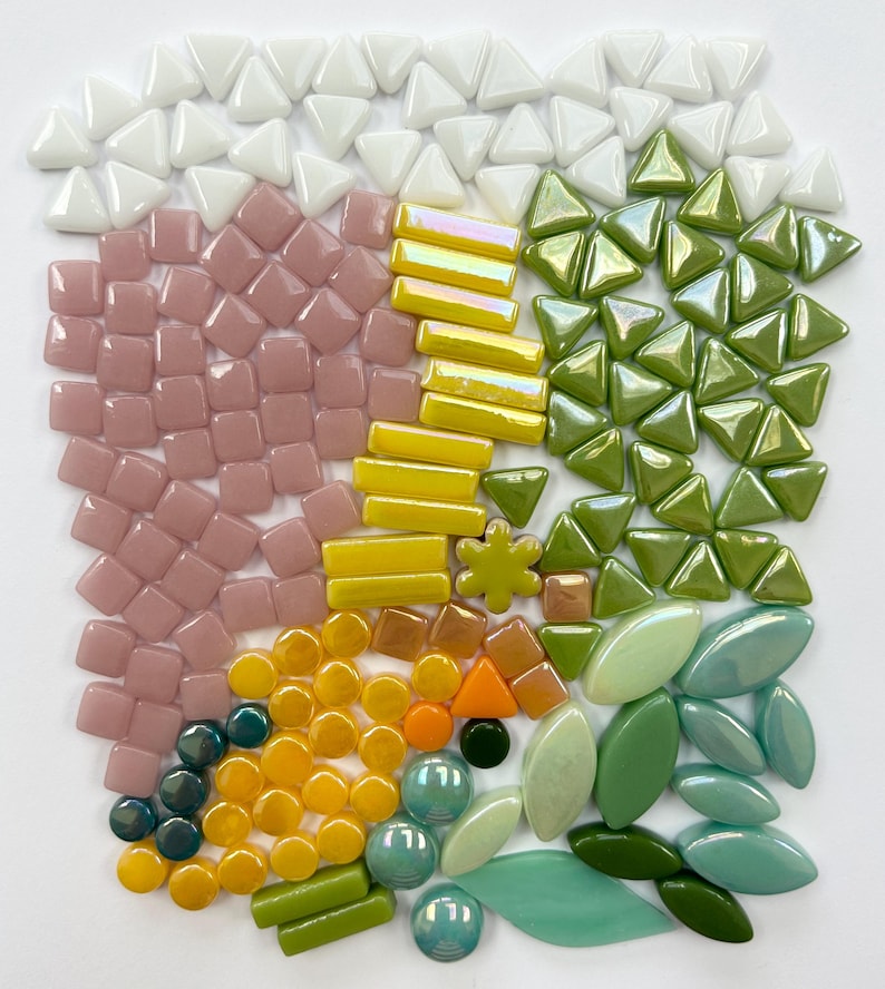 May include: Assortment of colorful glass mosaic tiles in various shapes and sizes, including squares, triangles, circles, and ovals. The tiles are in shades of white, pink, yellow, green, and blue.