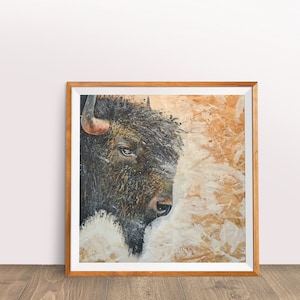 May include: A framed painting of a bison's head with a textured background of brown and white paint.