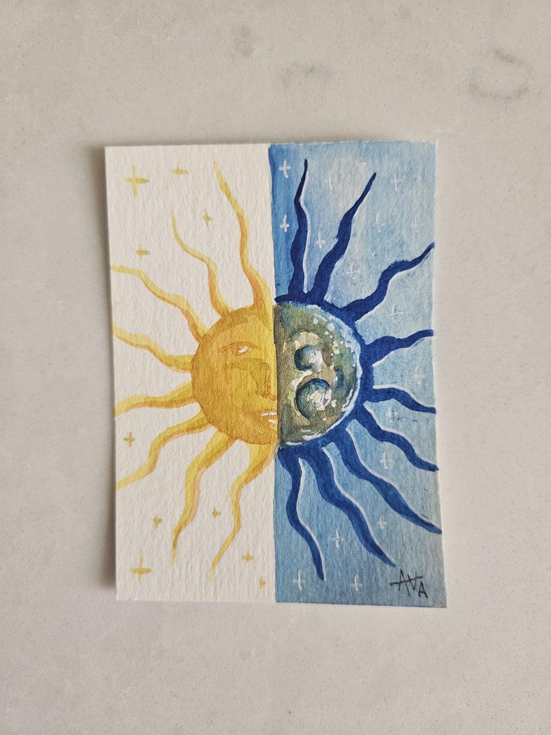 May include: Watercolor painting of the sun and moon, split vertically. The sun is yellow with a face, and the moon is blue with a face. Both sides have star accents. Signed "AVA" in the bottom right corner.