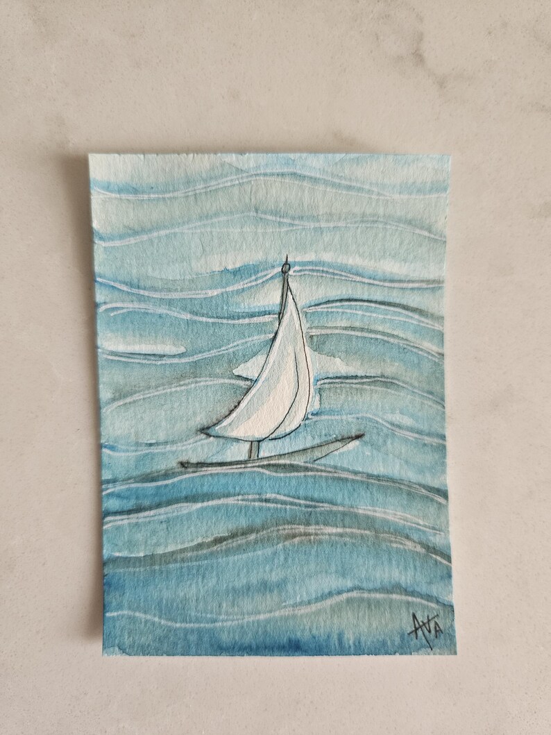 May include: Watercolor painting of a sailboat on blue water. The boat has a white sail and a black hull. The water is depicted with wavy blue brushstrokes. The artist's signature, "AVA", is in the bottom right corner.