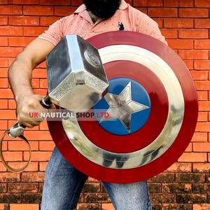 May include: A person holding a silver Mjolnir hammer and a red, white, and blue Captain America shield. The shield has a large silver star in the center.